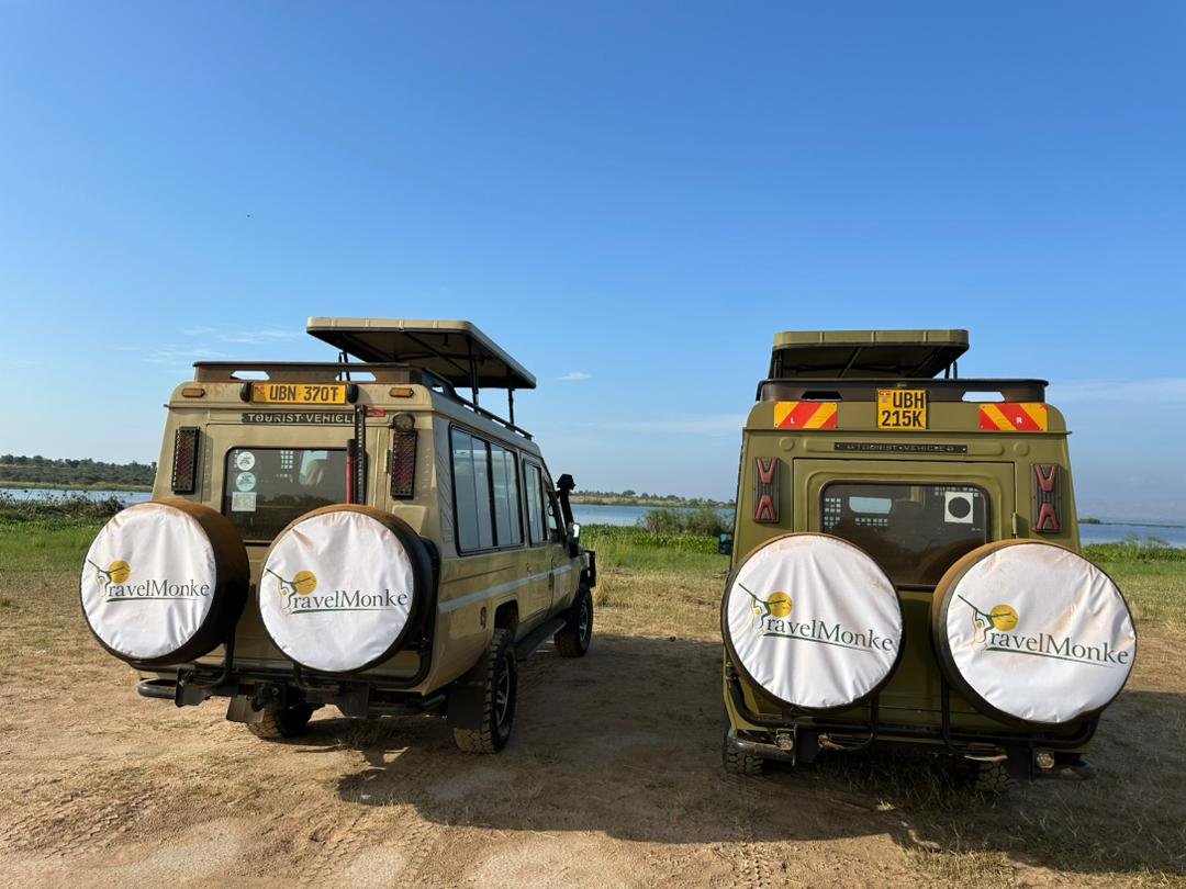 Two Travelmonke safari vehicles parked beside the Nile